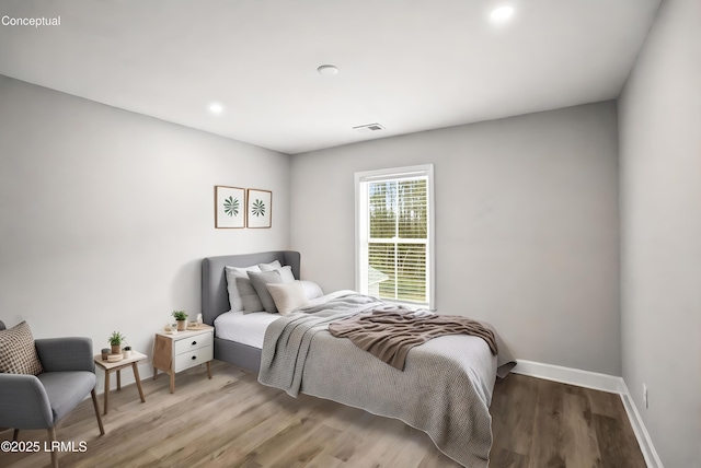 bedroom featuring visible vents, baseboards, wood finished floors, and recessed lighting