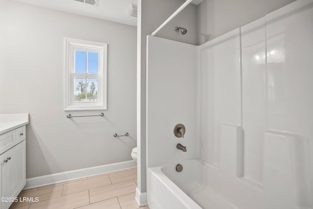 full bath with visible vents, baseboards, toilet, vanity, and washtub / shower combination