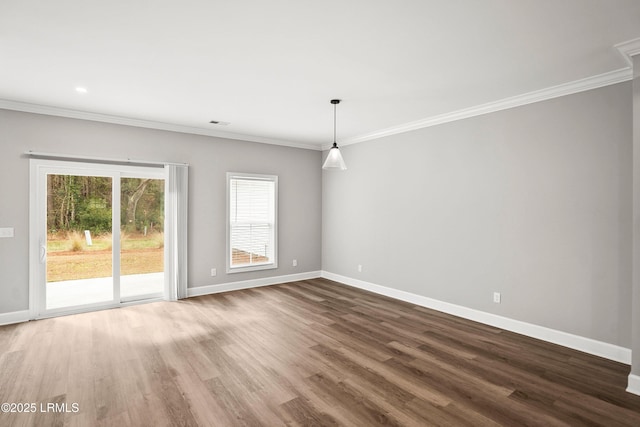 spare room featuring crown molding and baseboards