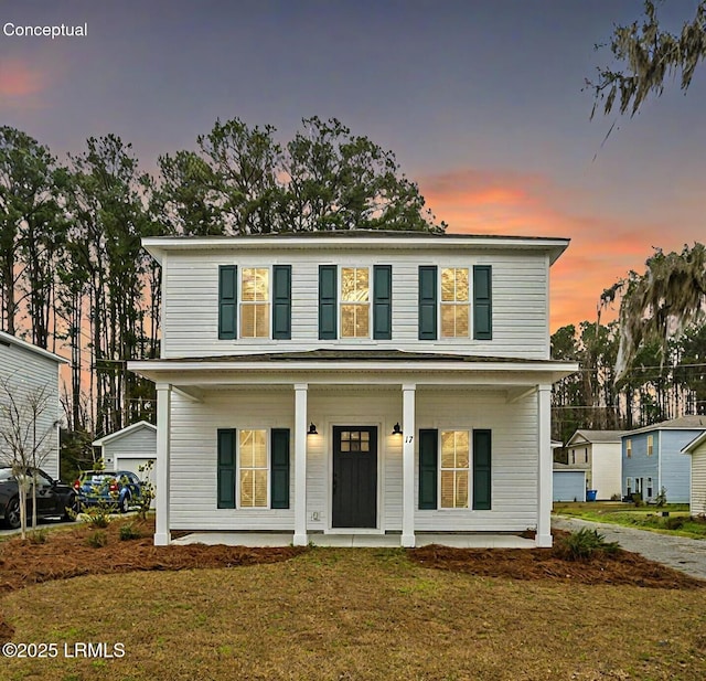 view of front of house featuring covered porch and a front yard