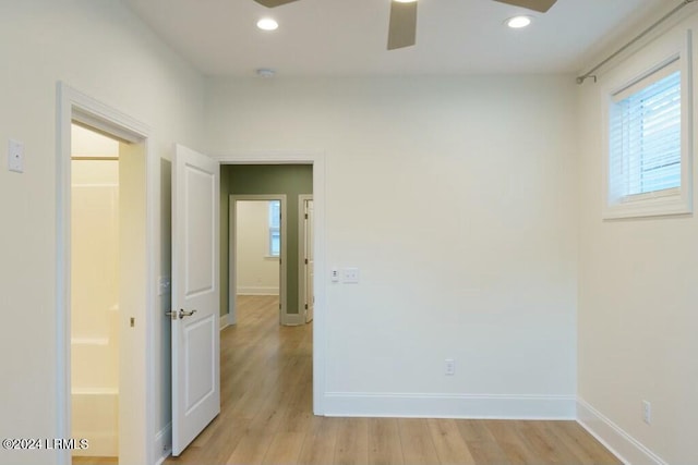 unfurnished room with ceiling fan and light hardwood / wood-style floors