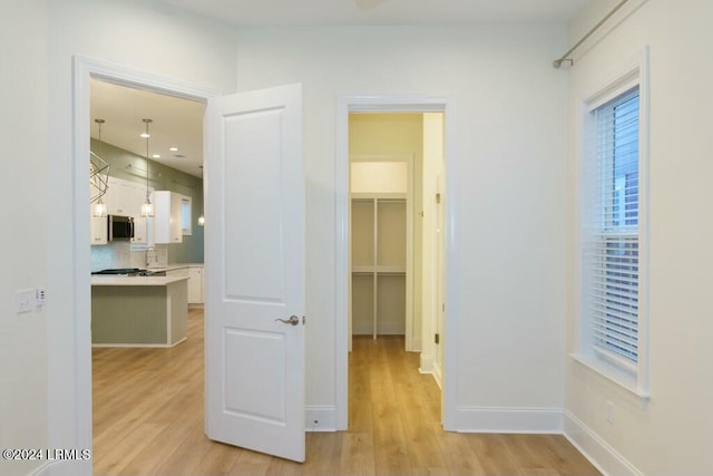 hall featuring sink and light hardwood / wood-style floors