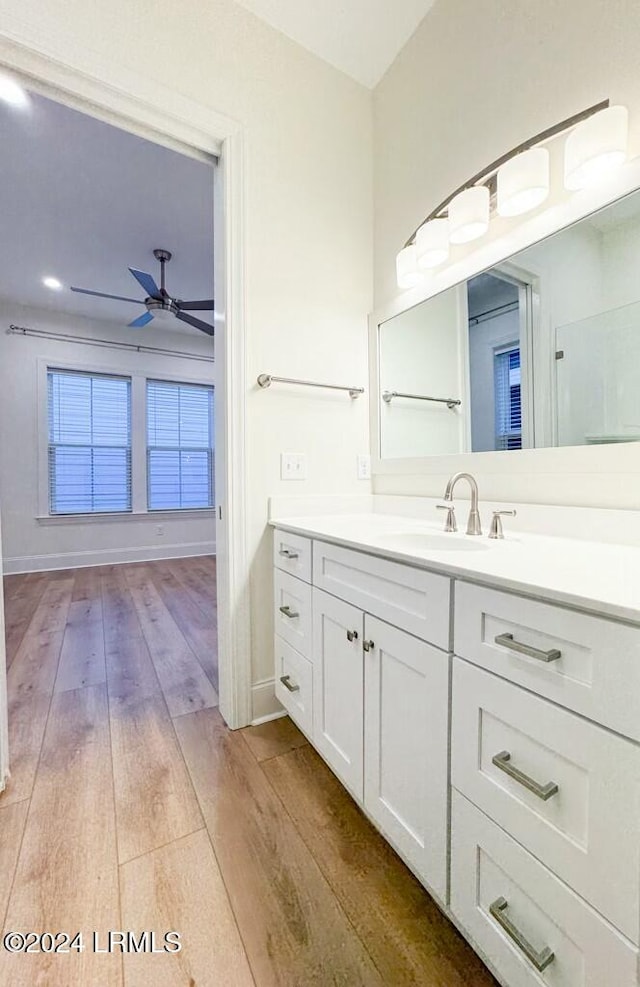 bathroom with ceiling fan, wood-type flooring, and vanity