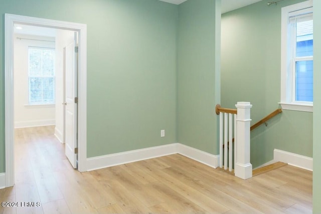 spare room featuring a healthy amount of sunlight and light wood-type flooring