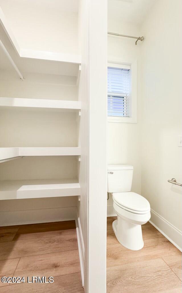 bathroom featuring toilet and hardwood / wood-style floors