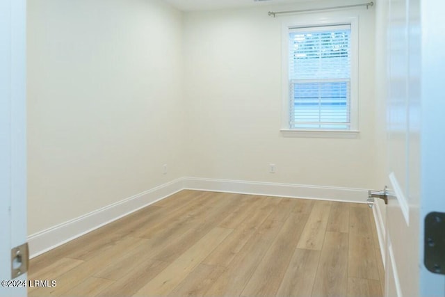 spare room with light hardwood / wood-style flooring