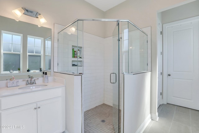 bathroom featuring vanity, a shower with shower door, and tile patterned flooring