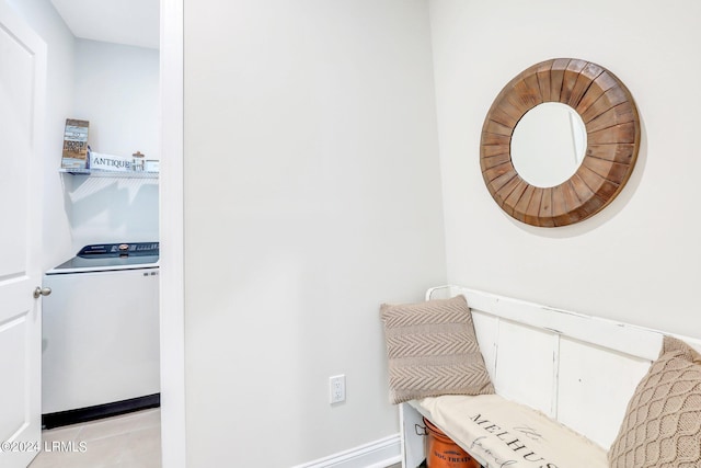 living area with light tile patterned flooring and washer / dryer