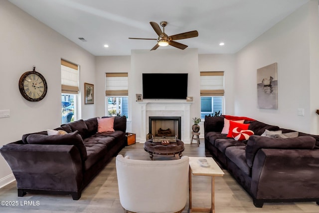 living room featuring ceiling fan and light wood-type flooring