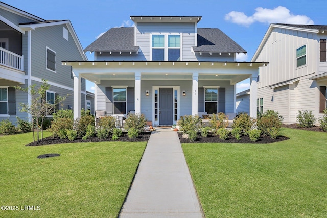 view of front of home with a front yard and covered porch