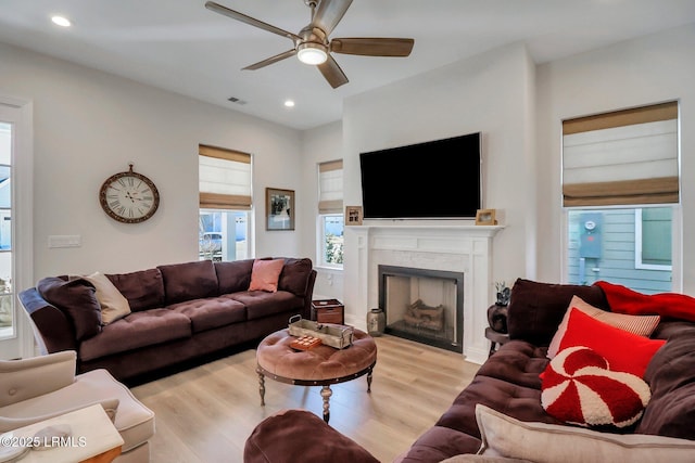 living room featuring ceiling fan and light wood-type flooring