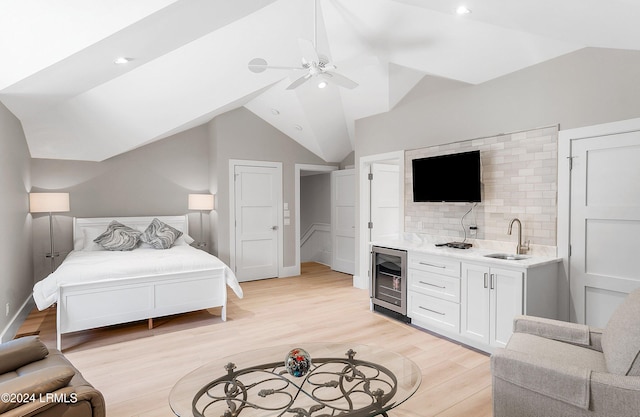 bedroom with vaulted ceiling, sink, beverage cooler, ceiling fan, and light hardwood / wood-style floors