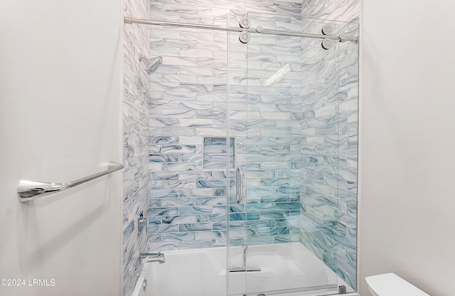 bathroom featuring shower / bath combination with glass door