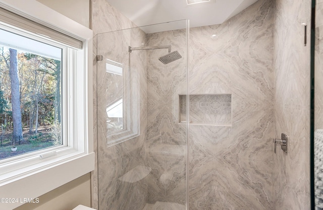 bathroom featuring a shower with door