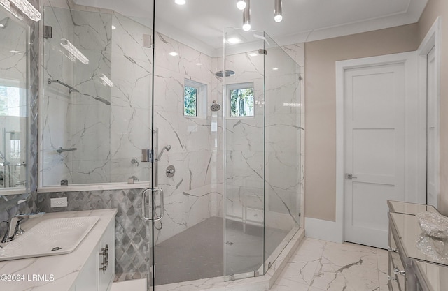 bathroom with vanity, a shower with shower door, and ornamental molding