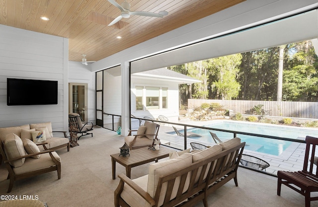 interior space with ceiling fan, plenty of natural light, and wooden ceiling