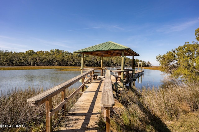 view of dock with a gazebo and a water view