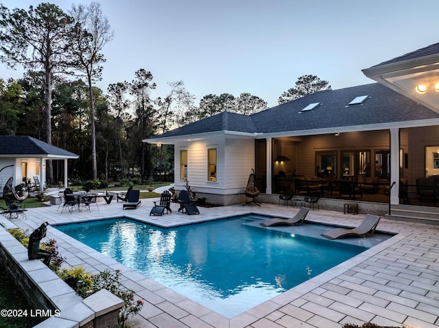 view of swimming pool with a patio and an outdoor structure