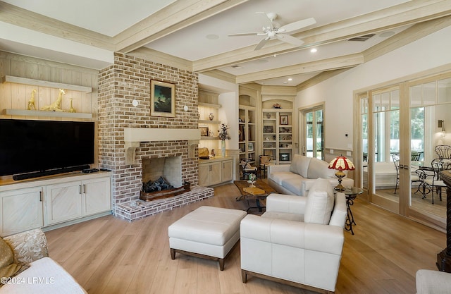 living room with french doors, beam ceiling, light hardwood / wood-style floors, and built in features