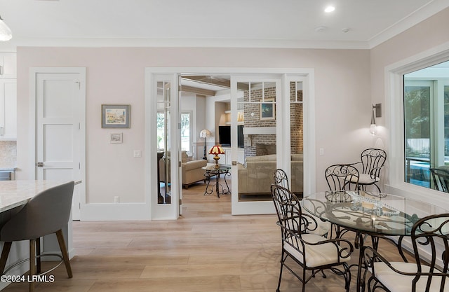 dining room featuring crown molding and light wood-type flooring