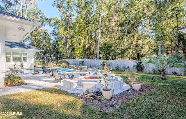 view of yard with an outdoor fire pit and a fenced in pool