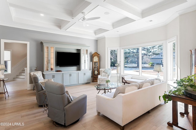 living room with coffered ceiling, light wood-type flooring, ornamental molding, beamed ceiling, and ceiling fan