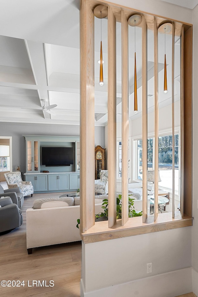 living room with coffered ceiling, beam ceiling, and light hardwood / wood-style floors