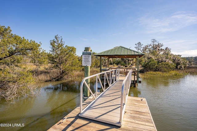 view of dock featuring a gazebo and a water view