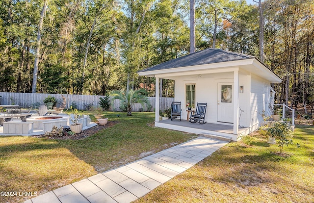 view of yard with an outbuilding and a fire pit