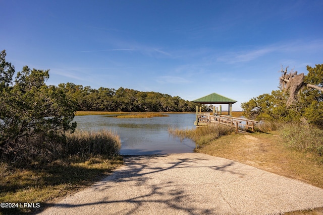 view of dock with a gazebo and a water view