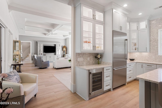 kitchen with white cabinetry, beam ceiling, coffered ceiling, beverage cooler, and stainless steel built in fridge