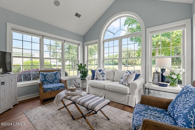 sunroom / solarium with visible vents and vaulted ceiling