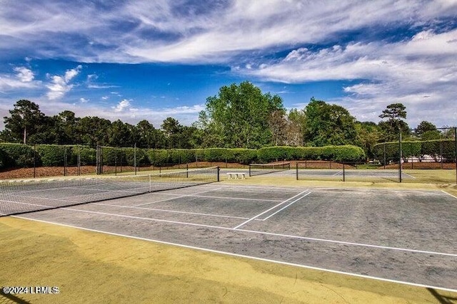 view of sport court featuring fence