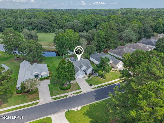 bird's eye view with a water view, a wooded view, and a residential view