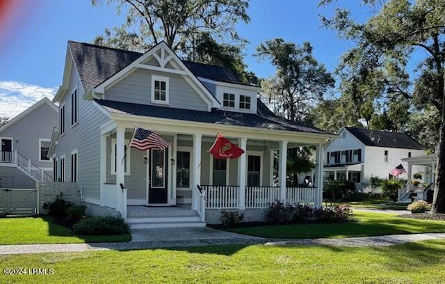 view of front of home with a porch and a front yard