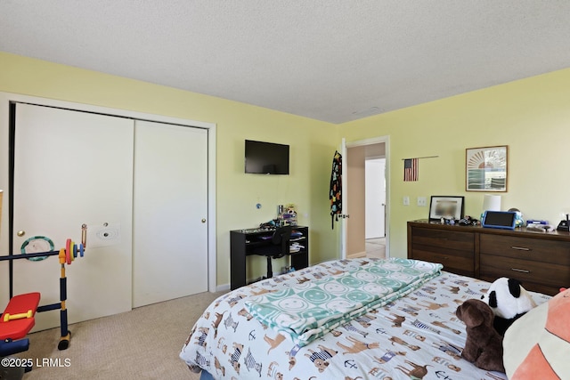 carpeted bedroom featuring a textured ceiling and a closet