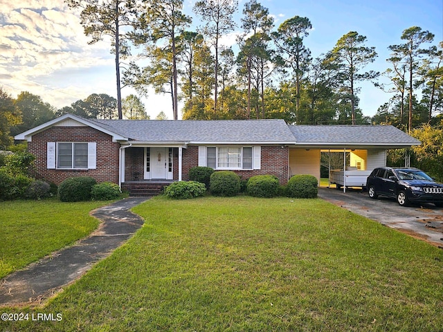 single story home featuring a front lawn and a carport