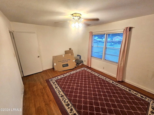 unfurnished room featuring ceiling fan and dark hardwood / wood-style flooring