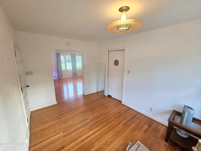 unfurnished room with light wood-type flooring