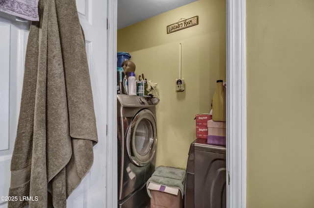 clothes washing area with washing machine and dryer