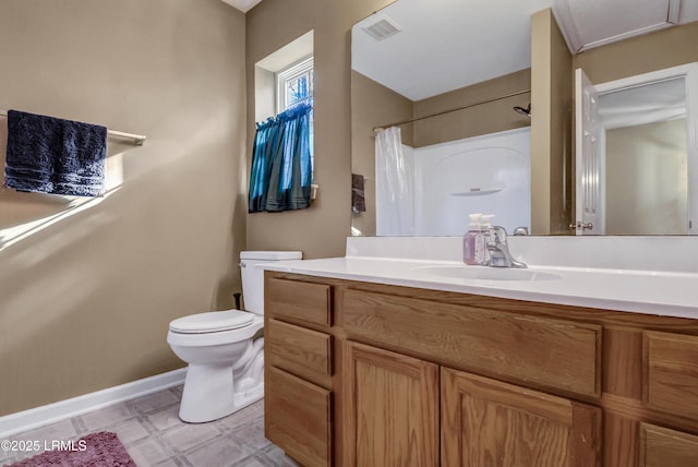 bathroom featuring vanity, curtained shower, and toilet