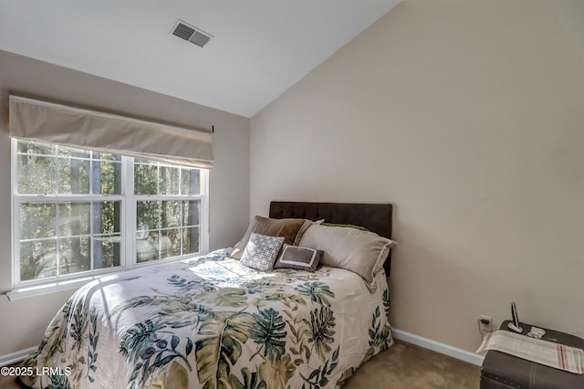 bedroom featuring vaulted ceiling and carpet flooring