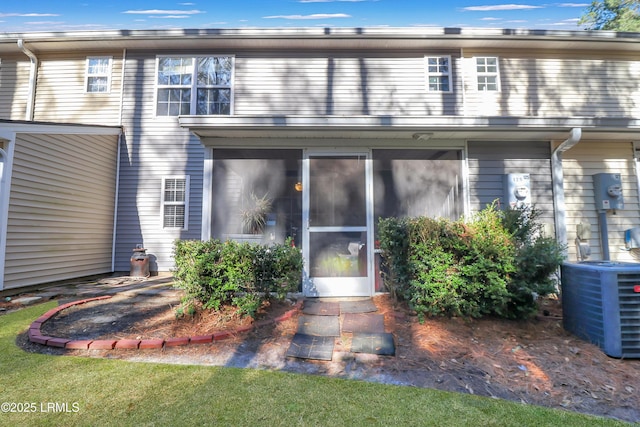 exterior space with a sunroom and central AC