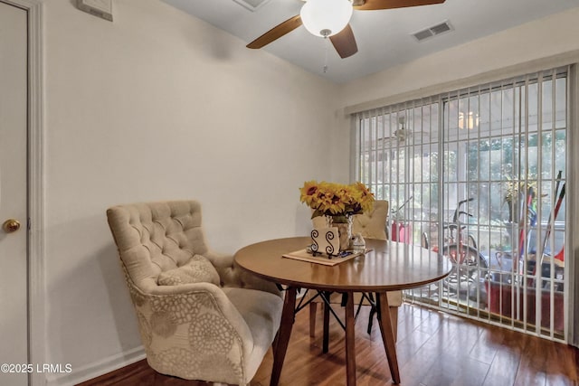 dining space with hardwood / wood-style floors and ceiling fan