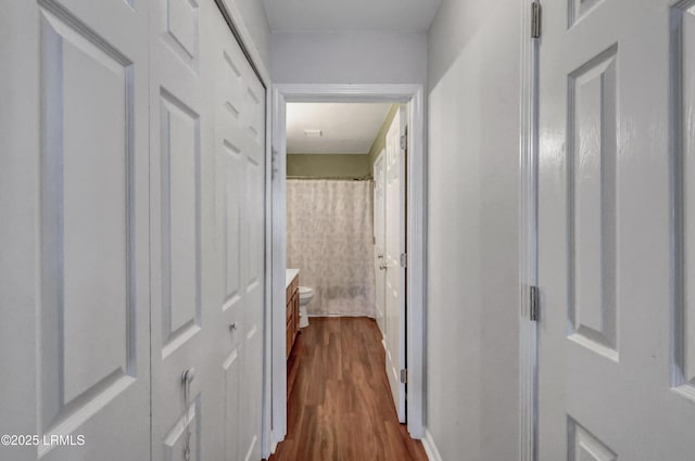 corridor featuring dark hardwood / wood-style floors