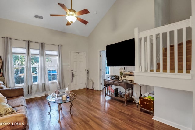 living room featuring ceiling fan, dark hardwood / wood-style floors, and high vaulted ceiling