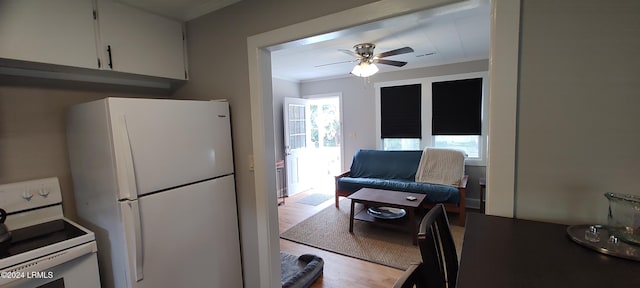 607 Waight St, Beaufort, SC 29902 - kitchen with white appliances, ceiling fan, ornamental molding, white cabinets, and light wood-type flooring