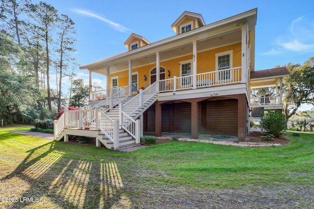 exterior space with stairs, covered porch, and a front yard