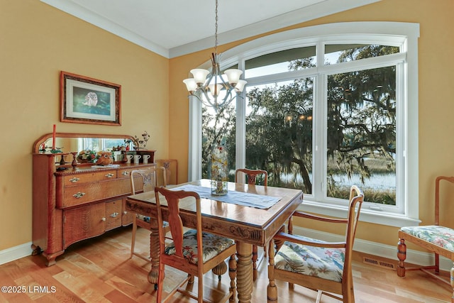 dining area featuring visible vents, plenty of natural light, and light wood-style flooring