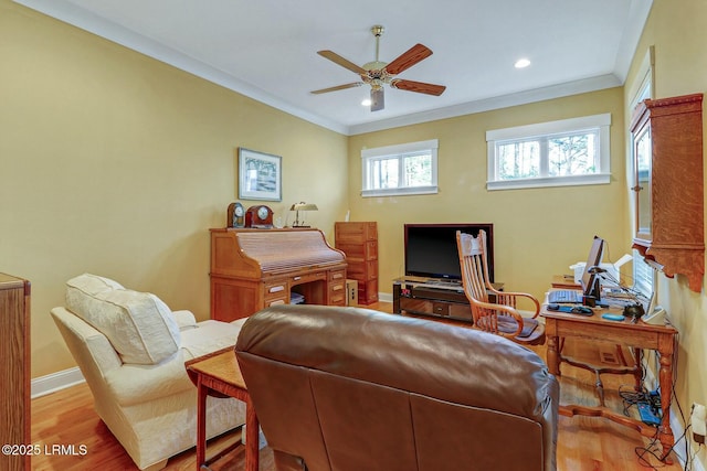 living room with a ceiling fan, wood finished floors, baseboards, and ornamental molding